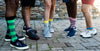 five people showing off their coloful sock styles